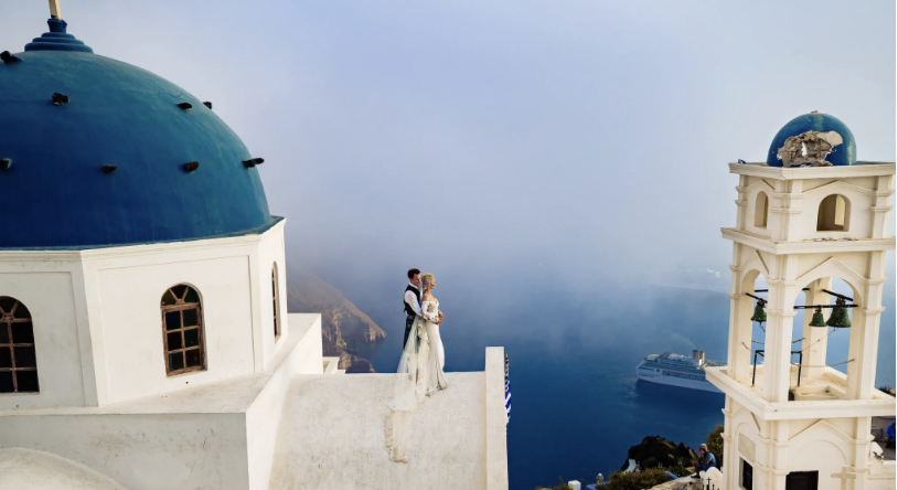 Premium live wedding band performing on a Santorini caldera terrace at sunset