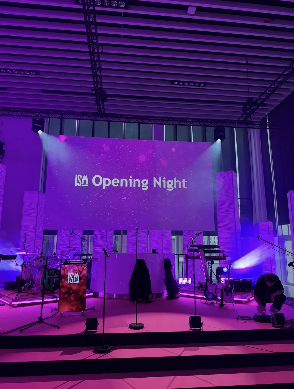 Stage set for a trade fair opening night with backline, lighting and large LED screen
