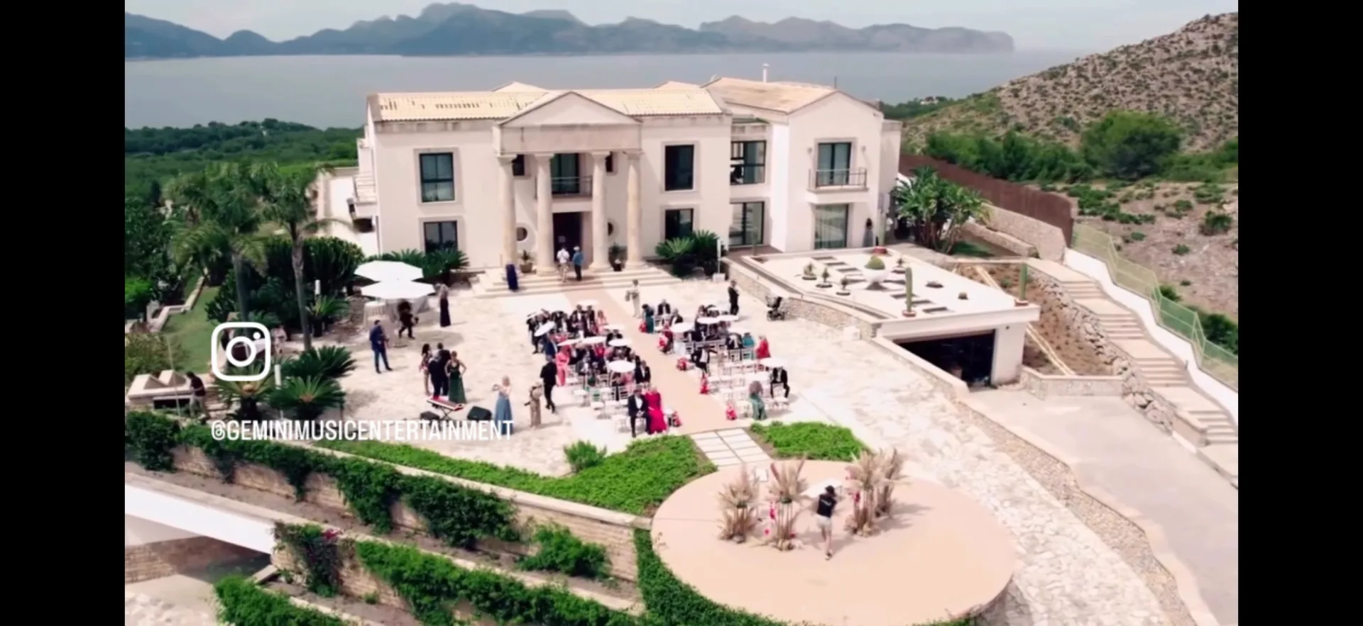 Aerial view of a luxury villa wedding on Mallorca with the bay in the background